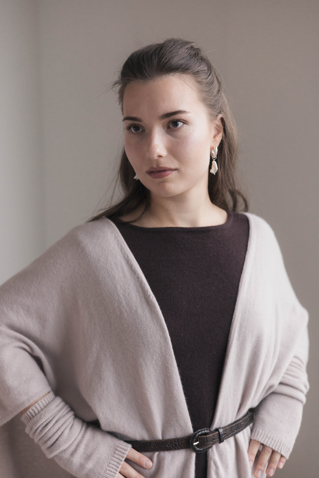 woman wearing open front cashmere poncho  beige draped over shoulders by Fiora Muse Helsinki
