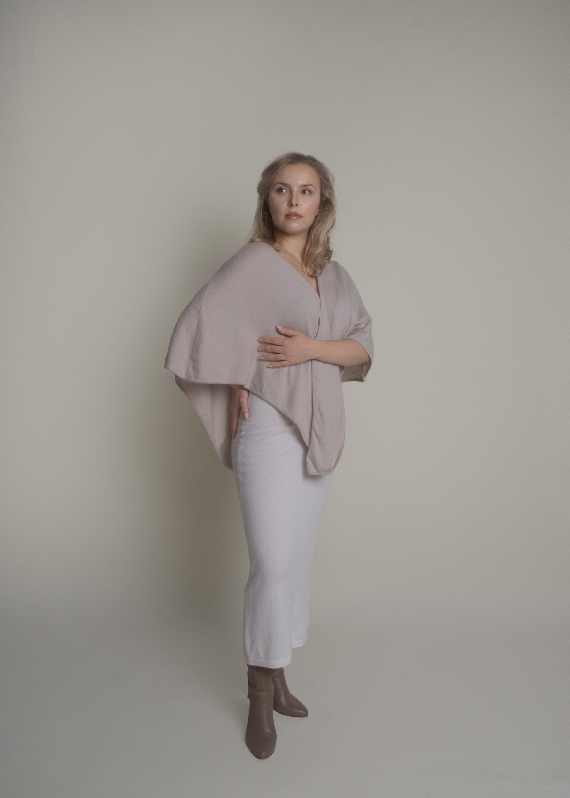 side view of open front cashmere poncho draped over shoulders