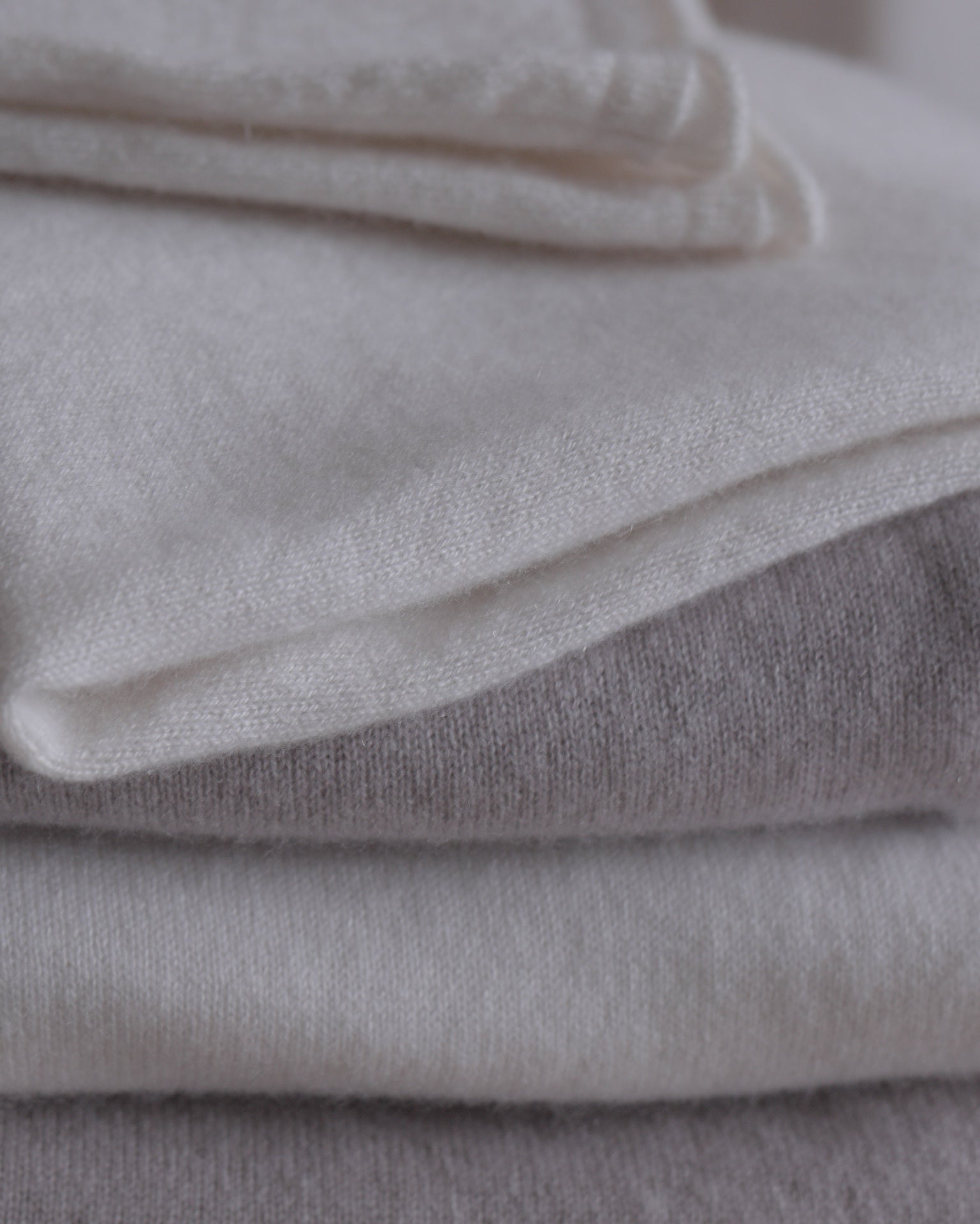 Stack of folded gray and white fabric