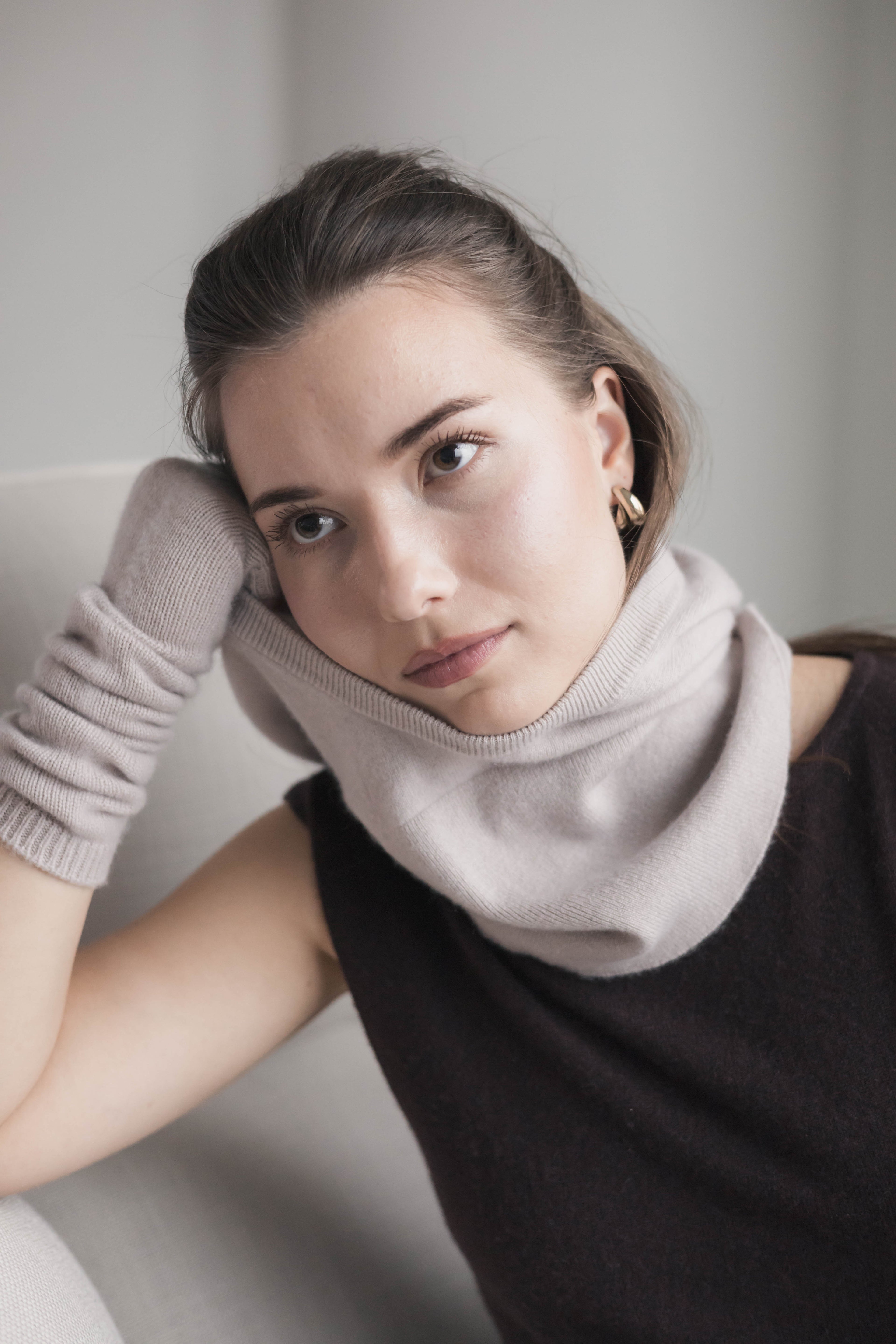 woman wearing cashmere hood pulled back 
as neck warmer