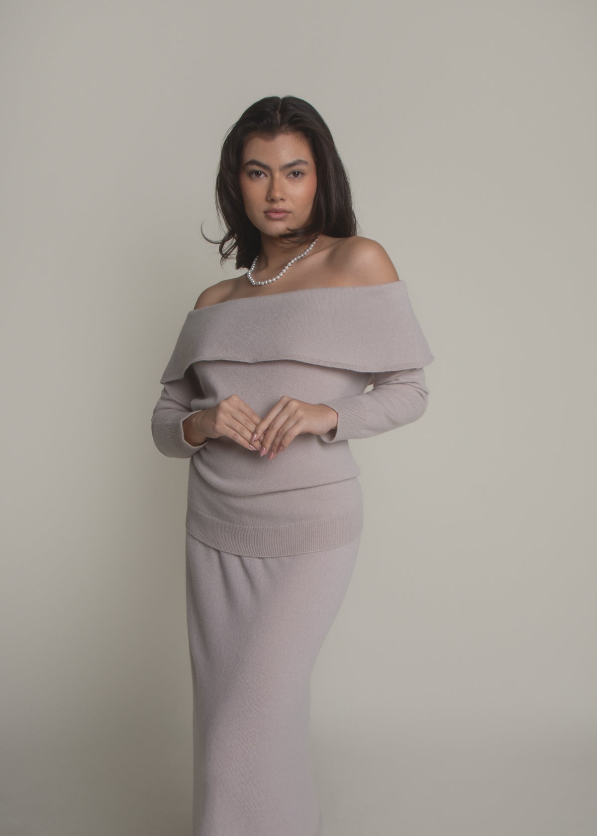 woman wearing beige off-shoulder cashmere sweater front view