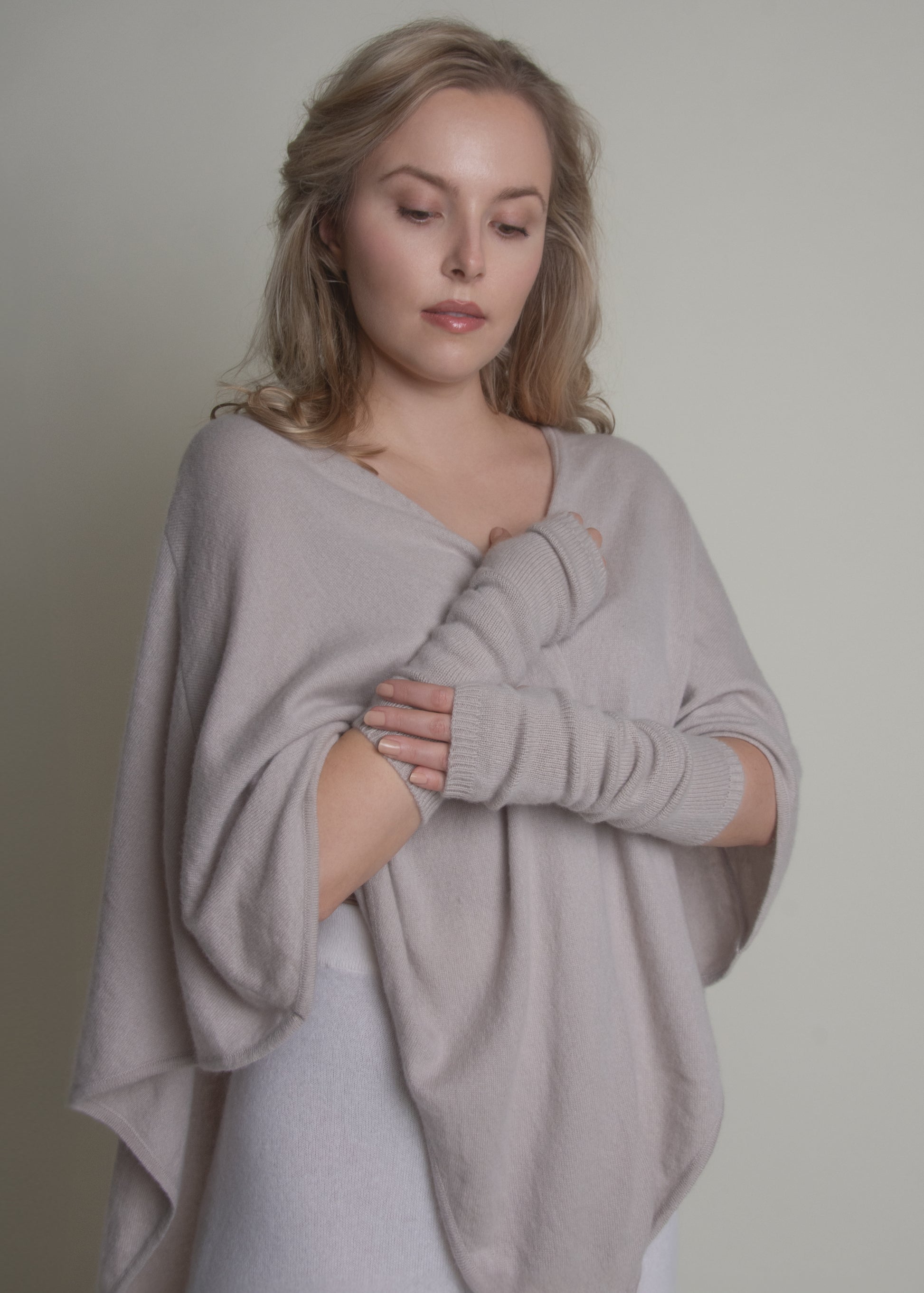 woman wearing beige cashmere arm warmers with matching wrap front view