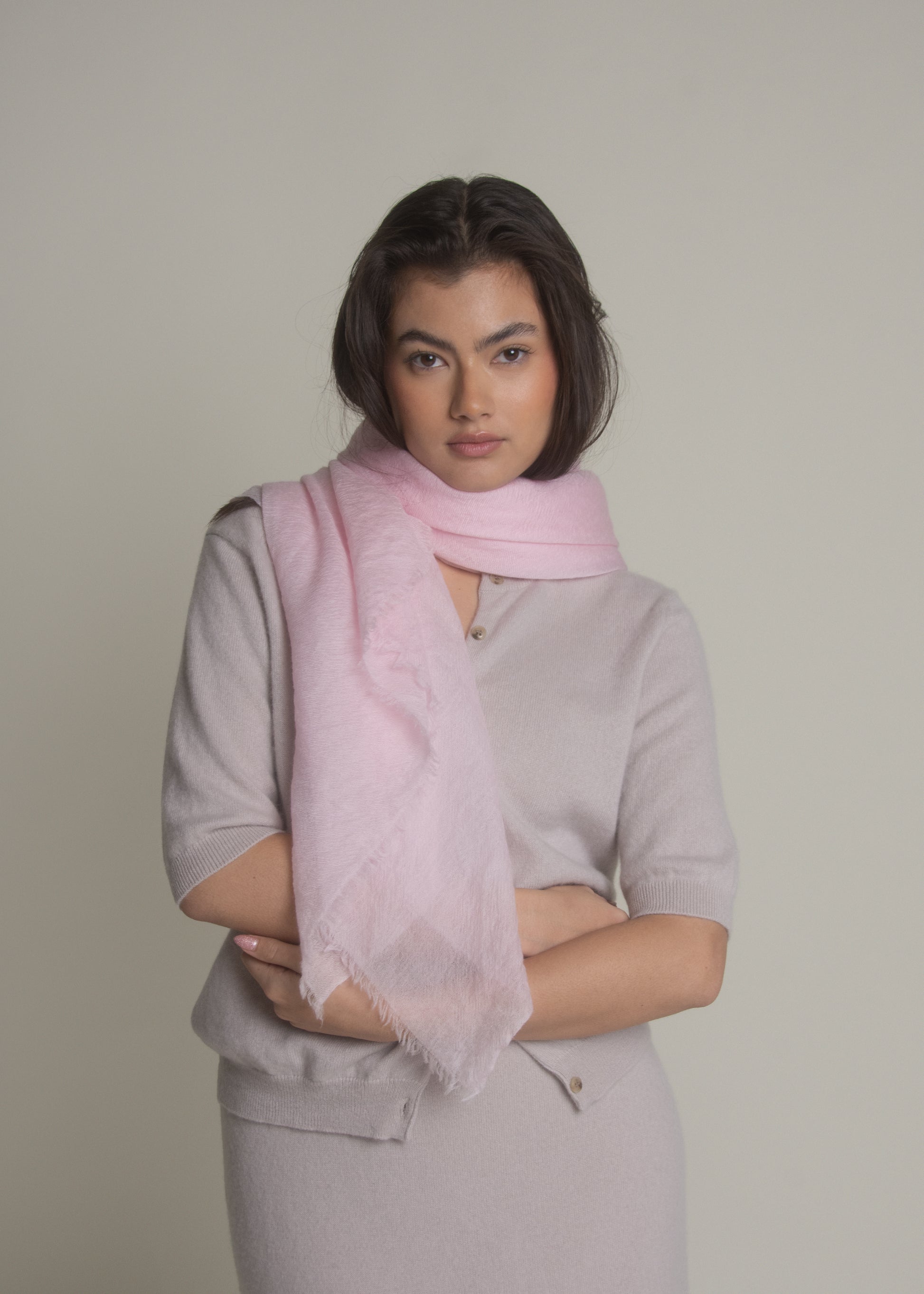 woman wearing pink ultralight cashmere shawl wrapped around neck