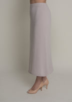 side view of beige a-line cashmere midi skirt showing movement