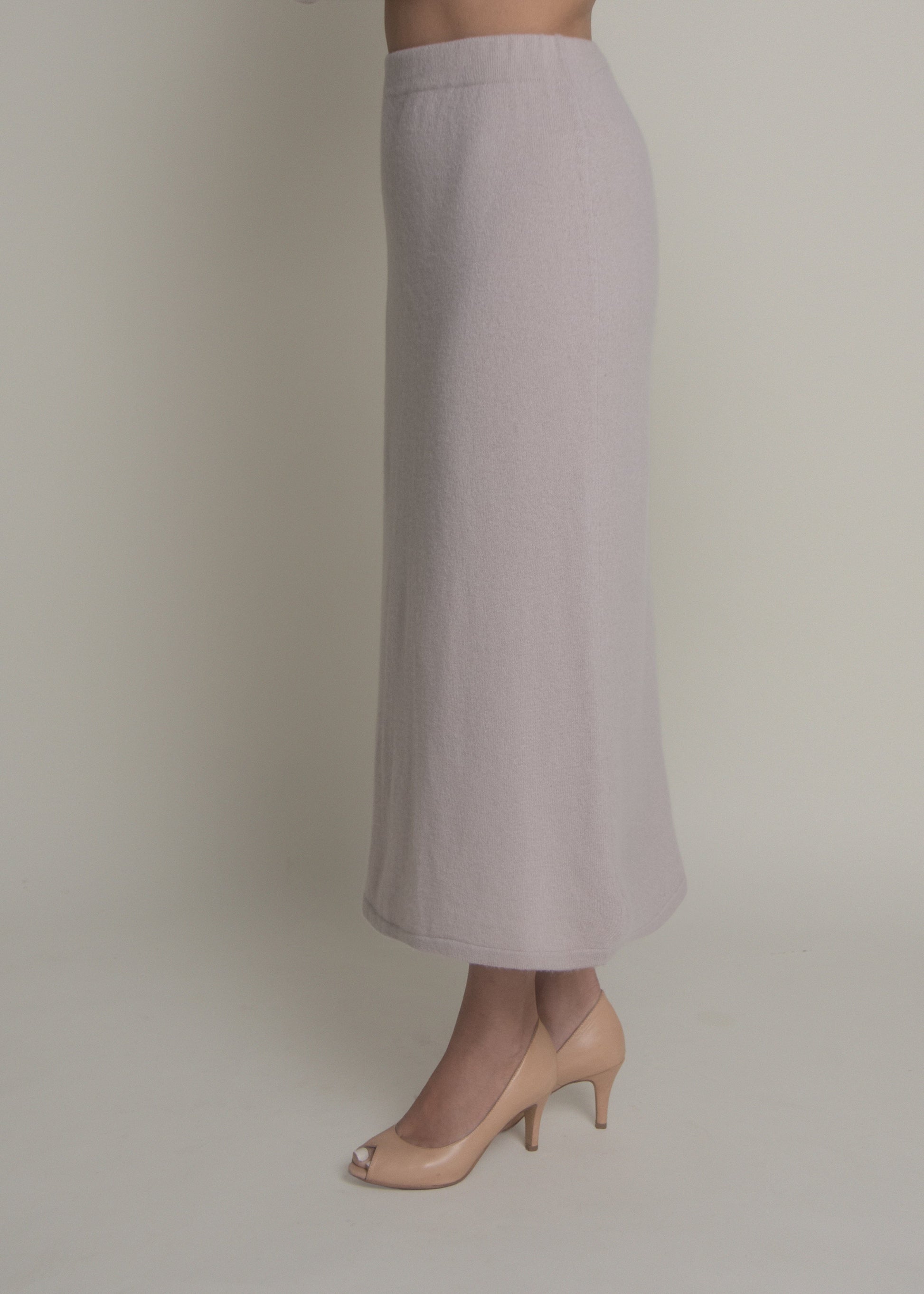 side view of beige a-line cashmere midi skirt showing movement