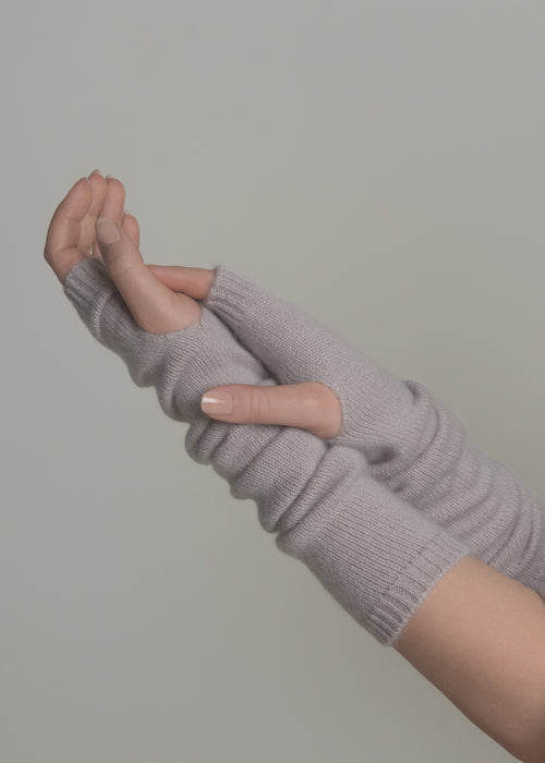 close-up of beige cashmere arm warmers on extended arms