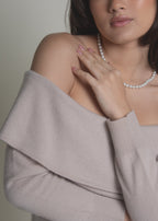 close-up of beige off-shoulder cashmere sweater bardot neckline