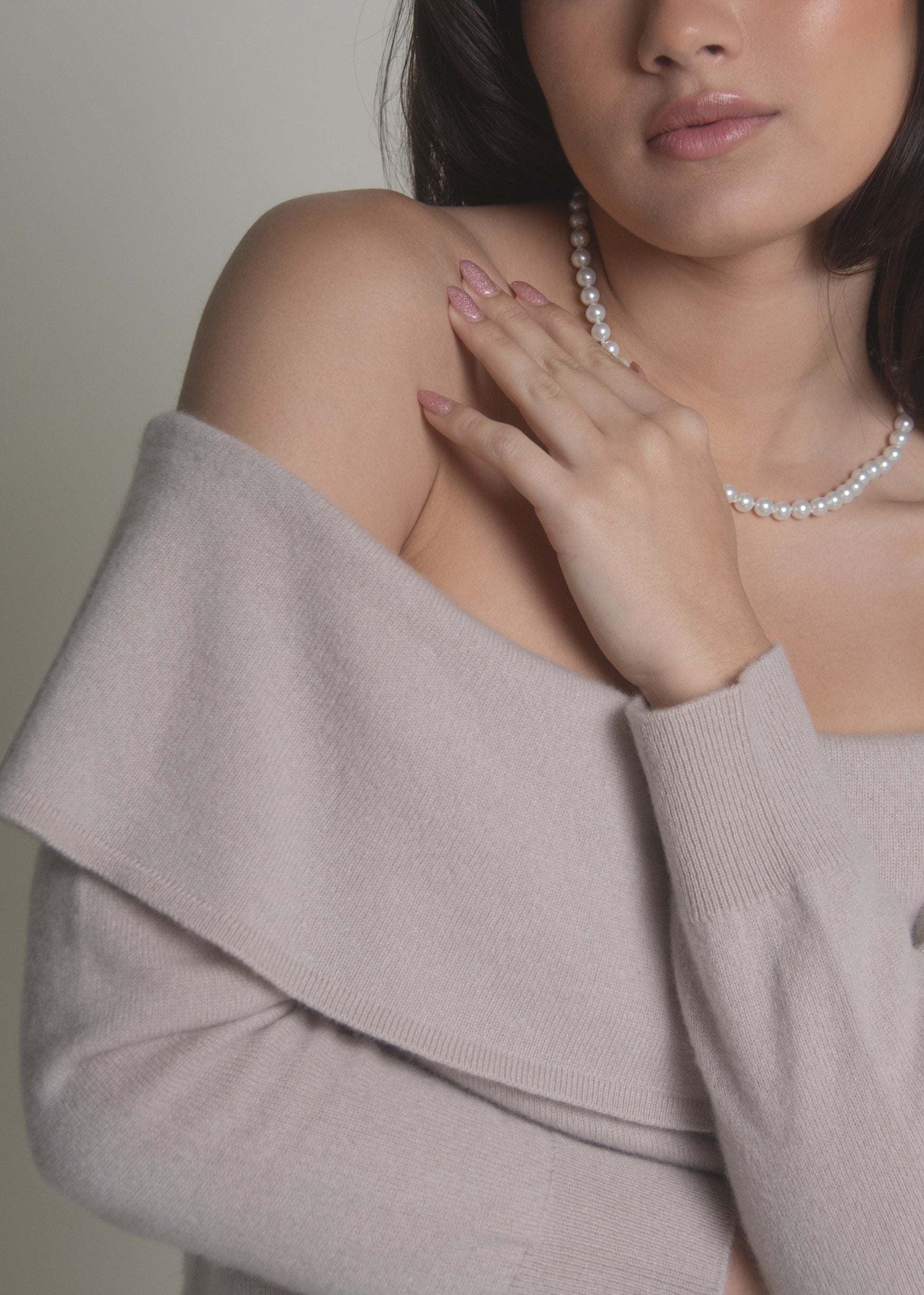close-up of beige off-shoulder cashmere sweater bardot neckline