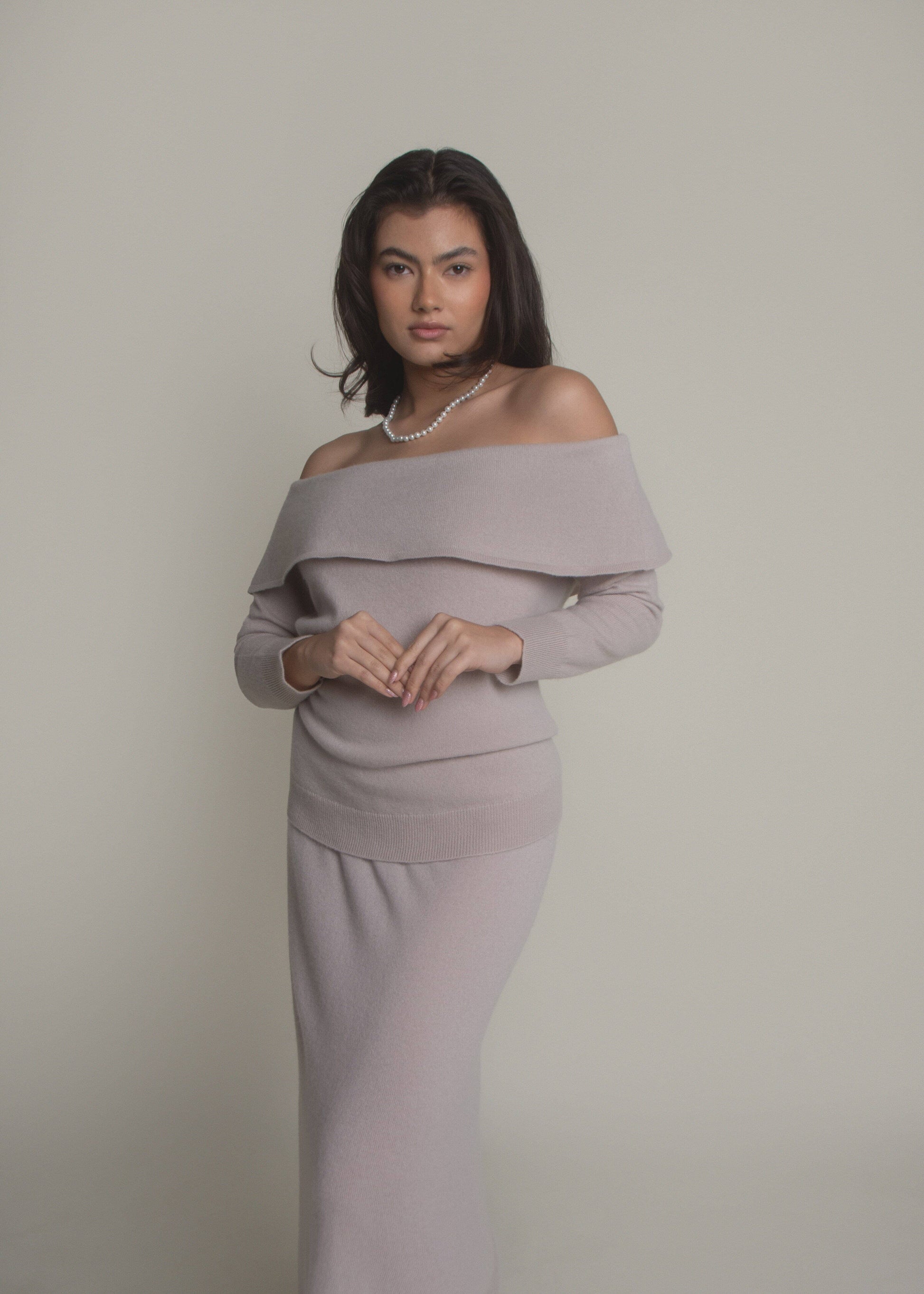 woman wearing beige off-shoulder cashmere sweater front view
