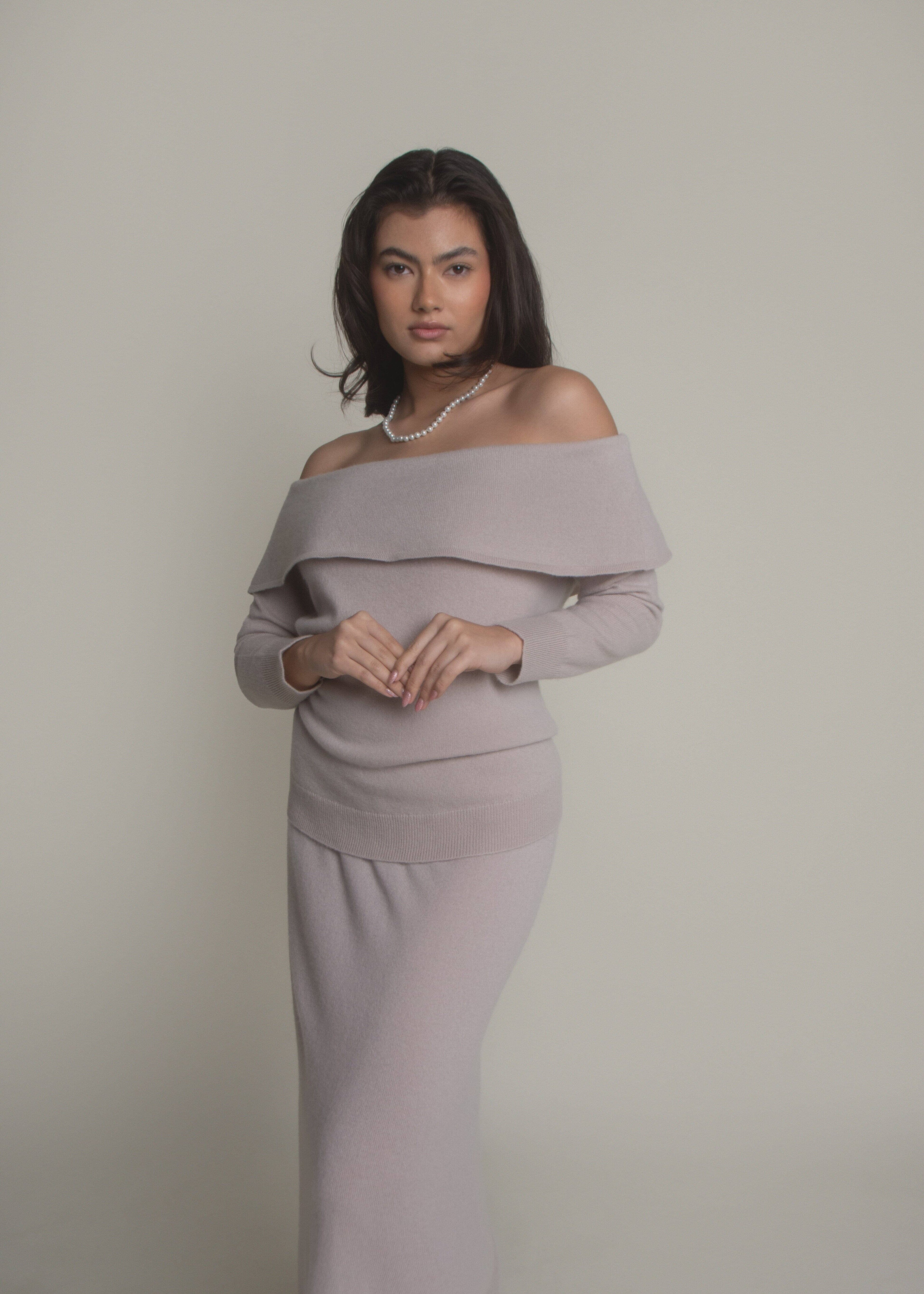 woman wearing beige off-shoulder cashmere sweater front view