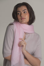 woman adjusting pink ultralight cashmere shawl with relaxed pose