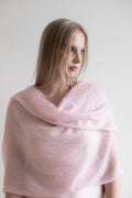 woman wearing pink cashmere shawl draped 
over shoulders